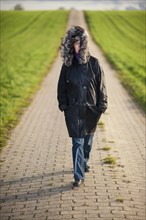 Woman walking on a field path
