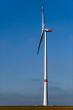 Recently built wind turbine against a blue sky