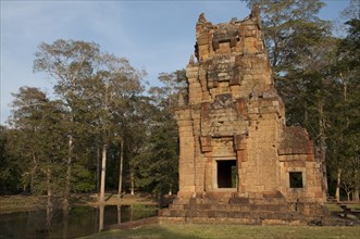 View of Khmer temple tower beside pond