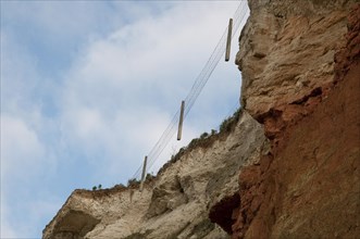 Suspended fencing caused by erosion of chalk and carrstone sea cliffs