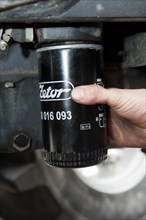Removing oil filter from tractor engine block