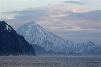 View of coastline with snow covered mountains