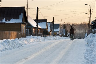 Cyclist on snow-covered road