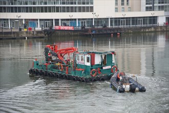 Maintenance boat on tidal river