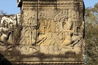 Bas-relief carved in stone depicting two dancing apsaras