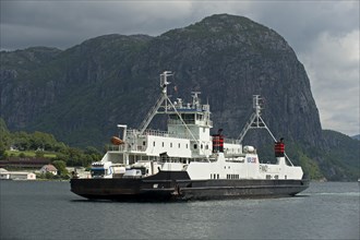 Finnoy ferry in front of Uburen rocky peak at the confluence of Lysefjord and Hogsfjord