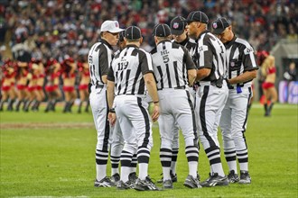 The referee crew discusses a ruling during the NFL International game between the Tampa Bay Buccaneers and the Chicago Bears on October 23