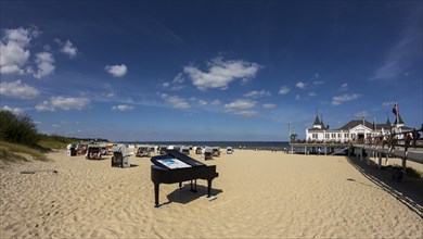 Pier with a grand piano on the beach