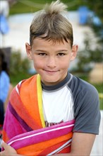 9-year-old boy with wet hair and a towel