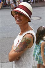 Smiling woman wearing a Panama hat and a summer dress