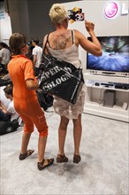 Mother and daughter playing a games console during the Gamescom 2012