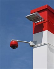 360-degree camera on wall against blue sky