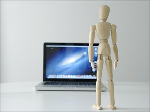 Mannequin in front of a laptop