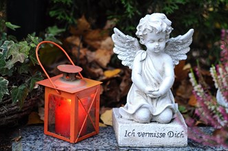 Angel sculpture and a grave lantern