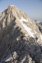Climber climbing along a ridge