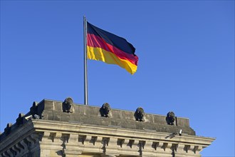 German flag on one of the towers of the Reichstag building