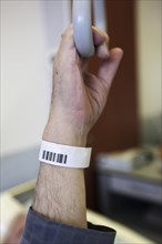 Senior with a barcode wristband in a hospital