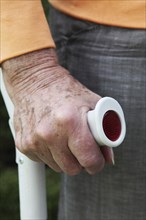 Hand a senior citizen with crutch