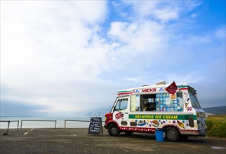 An ice cream van is parked on a coastal car park above Compton Bay on the Isle of Wight