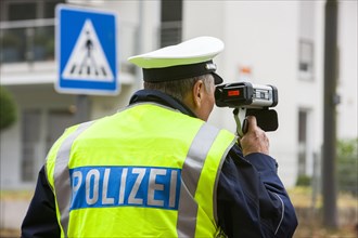 Policeman operating a laser speed gun