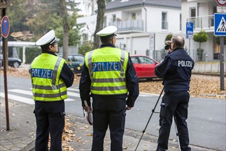Policemen operating a laser speed gun