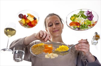 Young woman sitting at a glass table eating steak with vegetables and potatoes