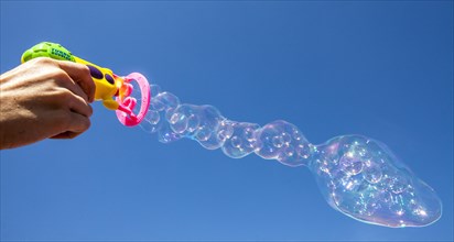 Smaller soap bubbles enclosed in larger bubbles from a bubble machine
