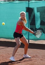 Young woman playing tennis in a holiday club