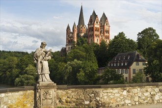 The statue of St. Nepomuk on the Alte Lahnbrucke bridge with the late Romanesque and early Gothic Limburg Cathedral of Sankt Georg