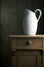 Old enamel jug on a small chest of drawers