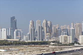Dubai skyline with a marina and barren land