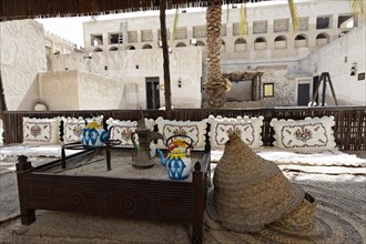 Traditional seating area with straw mats in the courtyard