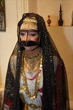 Arab bride wearing a traditional dress and headdress