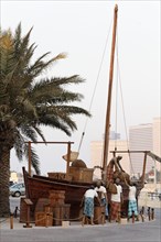 Arabs loading a wooden transport vessel