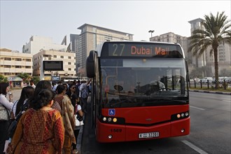 People getting on a bus to Dubai Mall