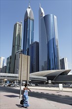Single pedestrian in front of skyscrapers