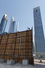 Construction site with a wooden partition in front of the skyline