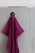 Berry-colored towel hanging on a hook
