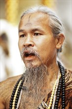 Animist hermit says healing prayers and tells fortunes at Doi Suthp Buddhist temple in Chiang Mai