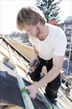 Carpenter at work on a roof truss