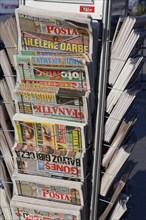 Daily newspapers in magazine racks