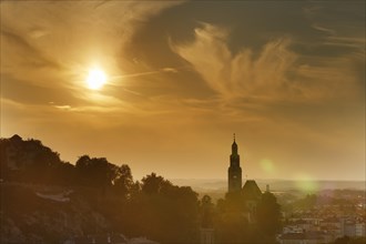 Moenchsberg mountain and Augustinerkirche church in Muelln in the evening light