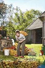 Boy carrying apples for making juice