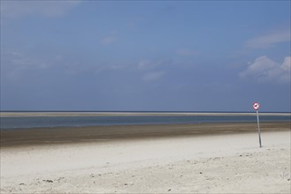 Deserted beach with a dogs prohibition sign on the island of Langeoog