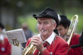 Brass player of the Weissensee marching band in traditional costume performing at the Naturparkfest festival in Techendorf