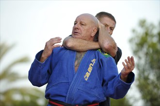 Two men doing martial arts training in a park