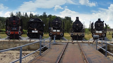 5 locomotives standing in front of the turntable