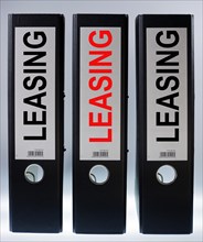 Three ring binders labelled "LEASING"