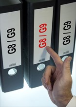 Hand pointing to a file folder labeled 'G8 - G9'