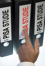 Hand pointing to a file folder labeled 'PISA'